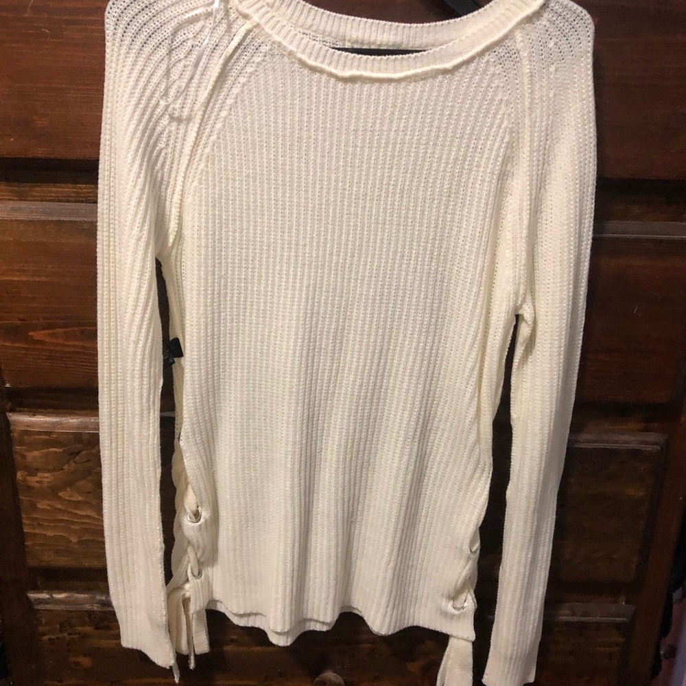 White knitted sweater with crisscross open sides